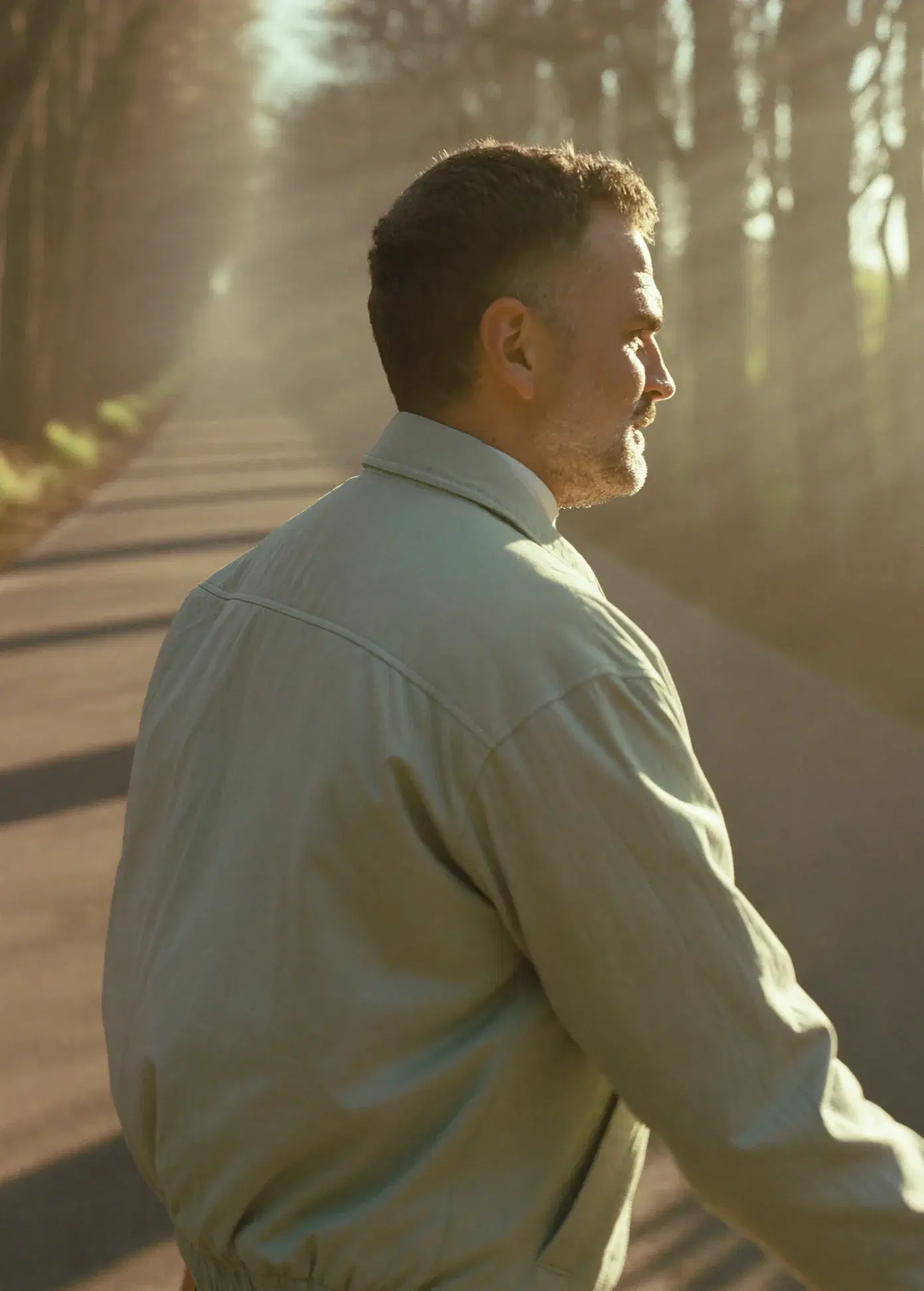 Man on a brisk morning walk in golden light
